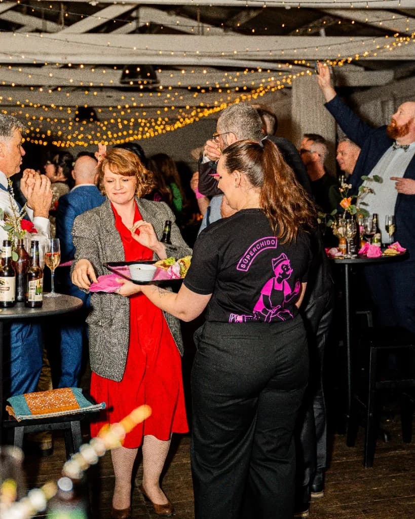 Superchido staff serving canapés at a wedding or celebration in Seddon