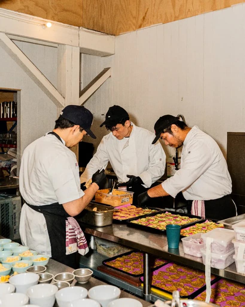 Superchido catering service at a venue with string lights and guests