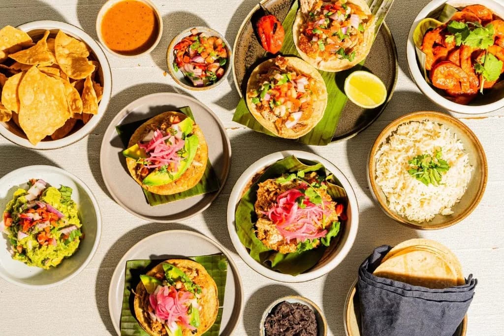 Colourful Mexican food spread — tacos, guacamole, chips and sides at Superchido Seddon