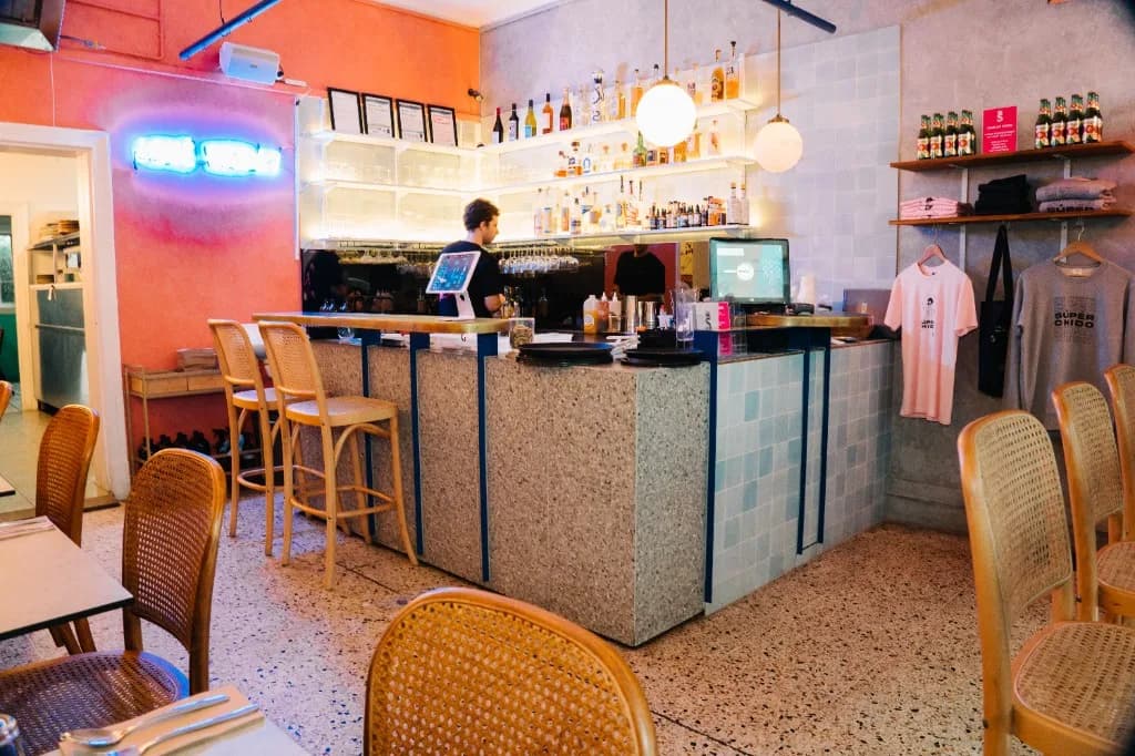 Superchido agave bar interior with neon sign and tequila shelves