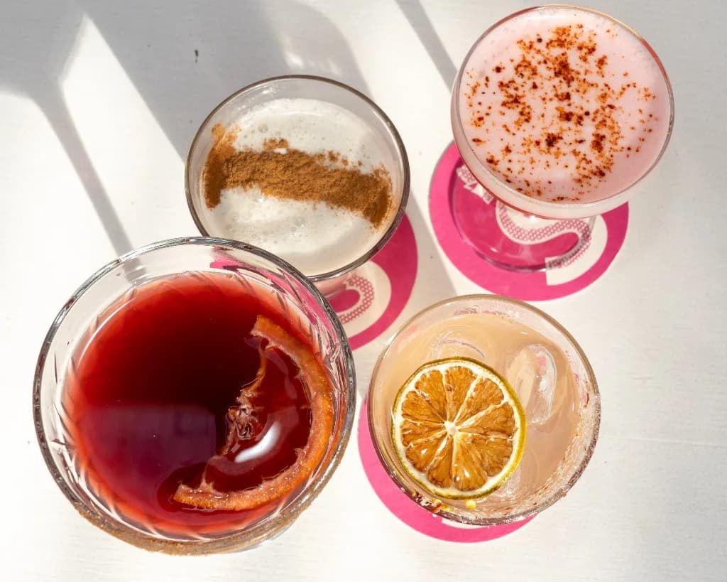 Colourful Superchido cocktails on pink coasters at the agave bar