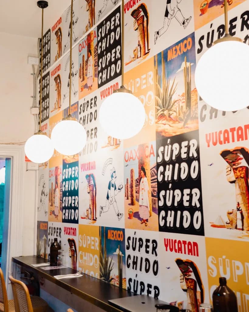 Colourful Súperchido poster wall with Mexican regional artwork in Seddon